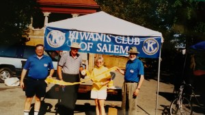 Salem Kiwanis booth at Easter egg hunt featuring four members.